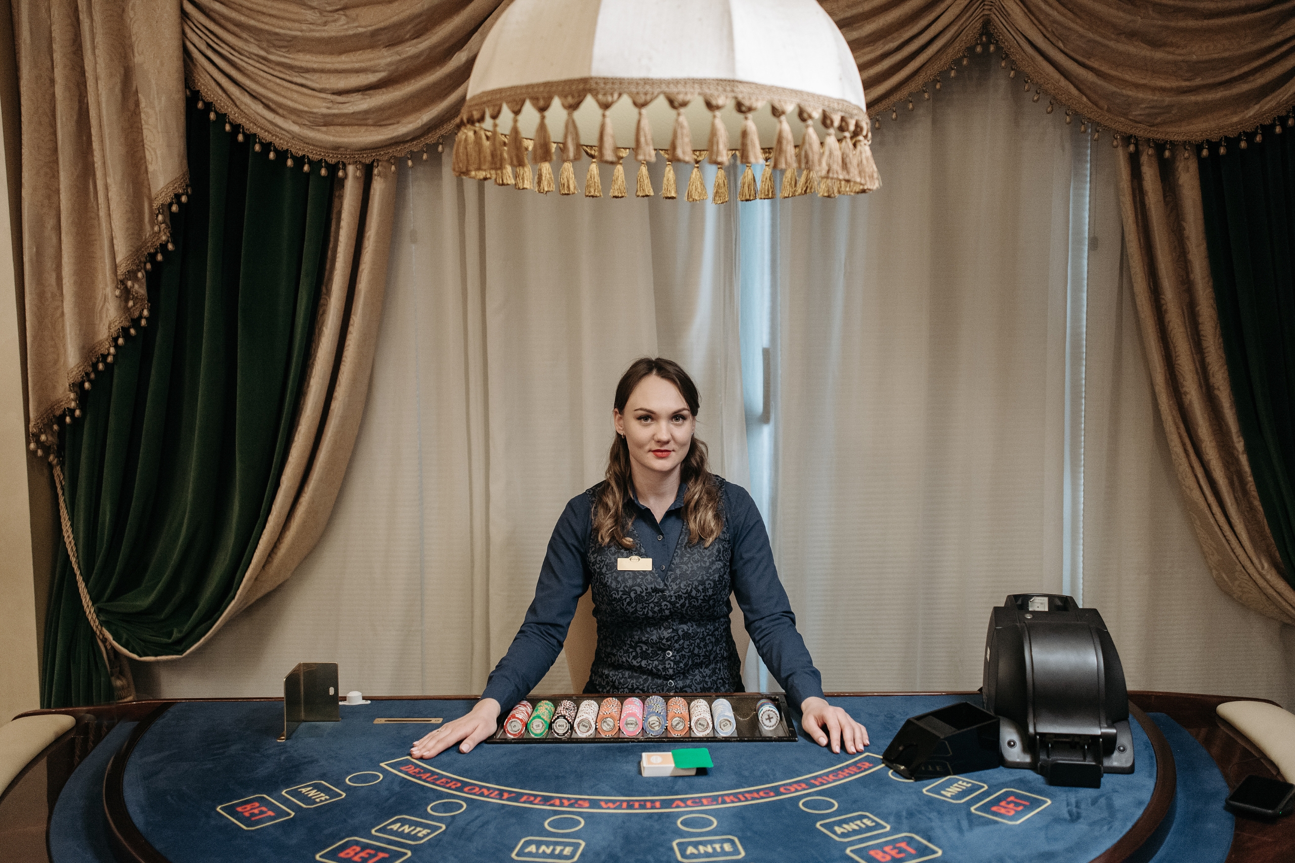 A Woman Card Dealer Posing and Smiling